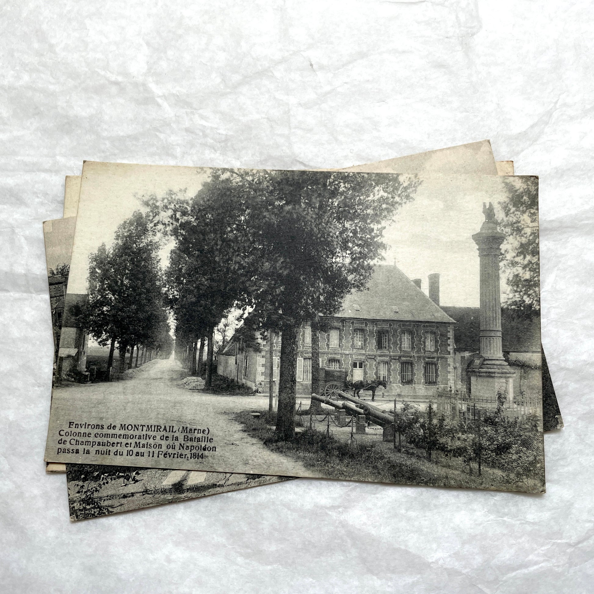 Lot of 1910s French postcards showing historic village scenes, old ramparts, a bridge, and a tower in France.