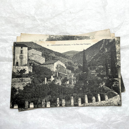 Lot of 1910s French postcards showing historic village scenes, old ramparts, a bridge, and a tower in France.