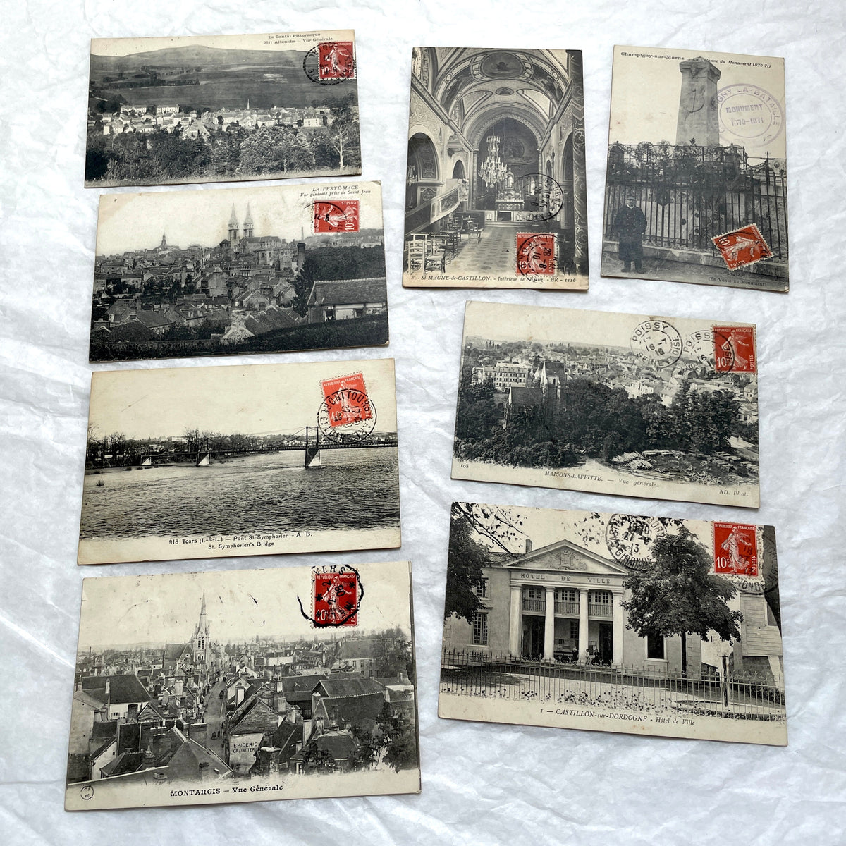 Lot of 8 1910s French postcards showing various historic town views, architecture, and landscapes with stamps.