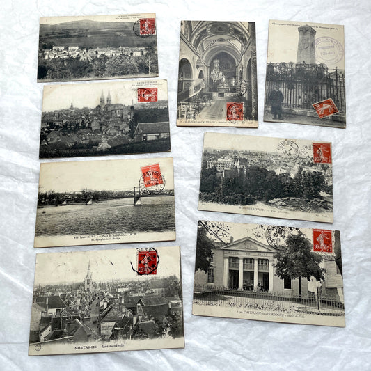 Lot of 8 1910s French postcards showing various historic town views, architecture, and landscapes with stamps.
