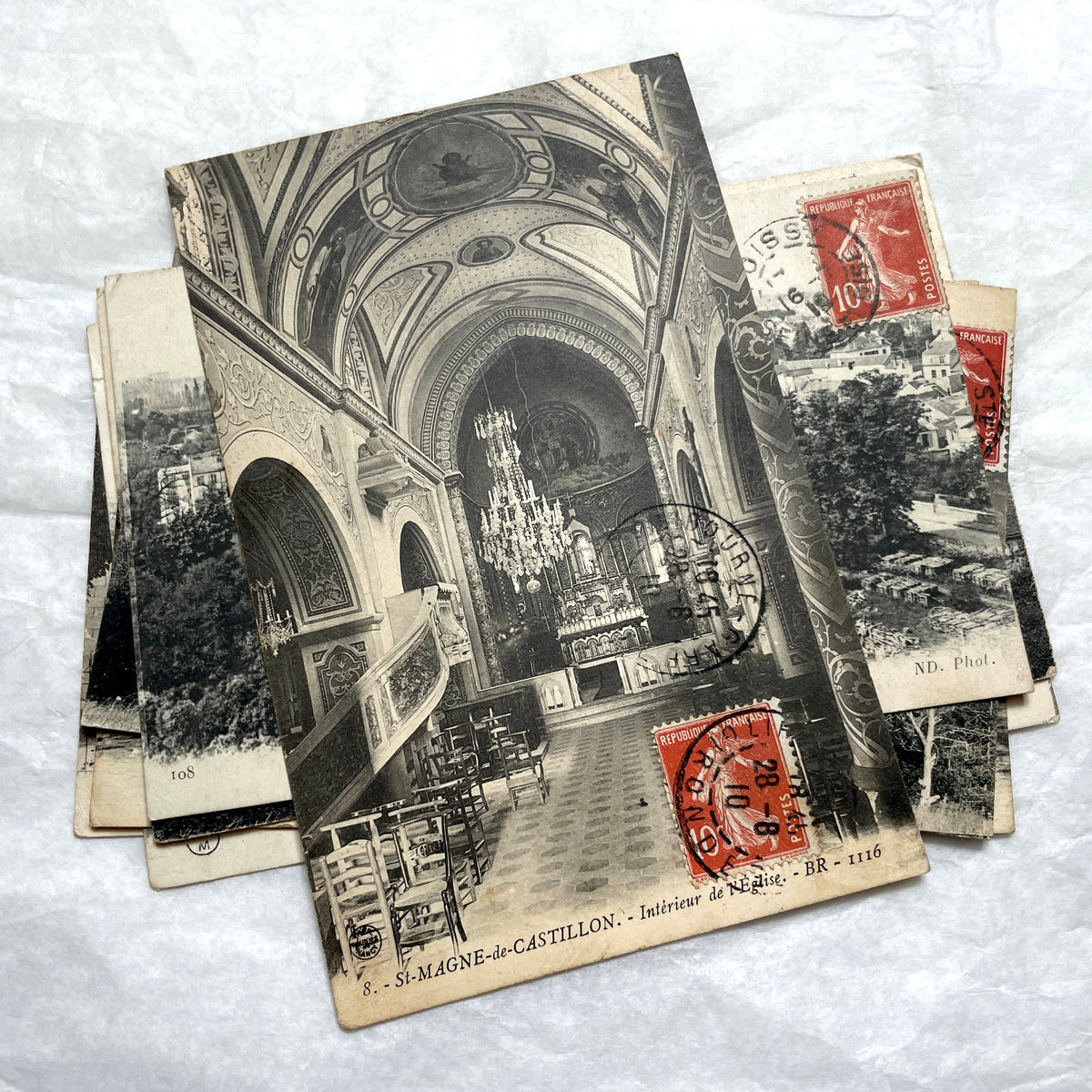 Lot of 8 1910s French postcards showing various historic town views, architecture, and landscapes with stamps.