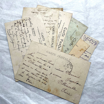 Lot of 8 1910s French postcards showing various historic town views, architecture, and landscapes with stamps.