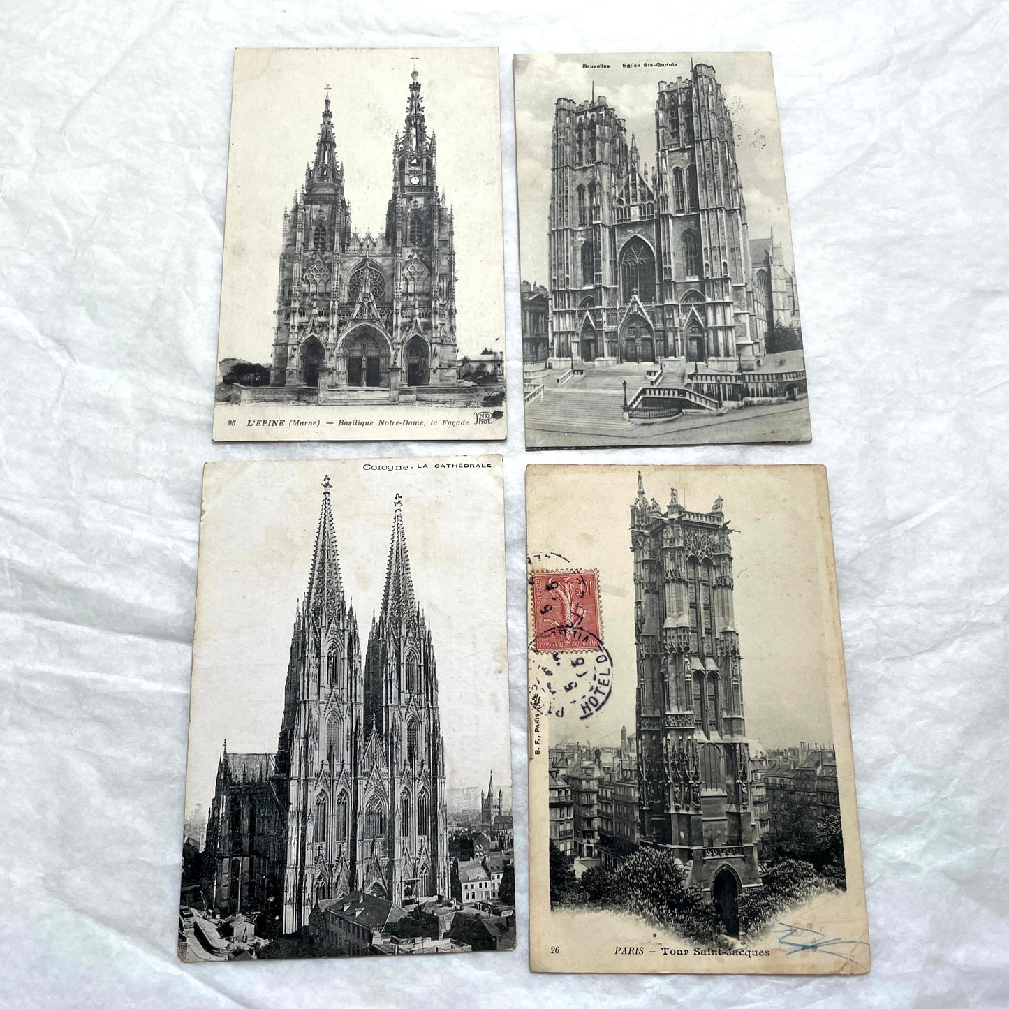 Four 1900s vintage postcards featuring detailed black and white views of European Gothic cathedrals and iconic towers.