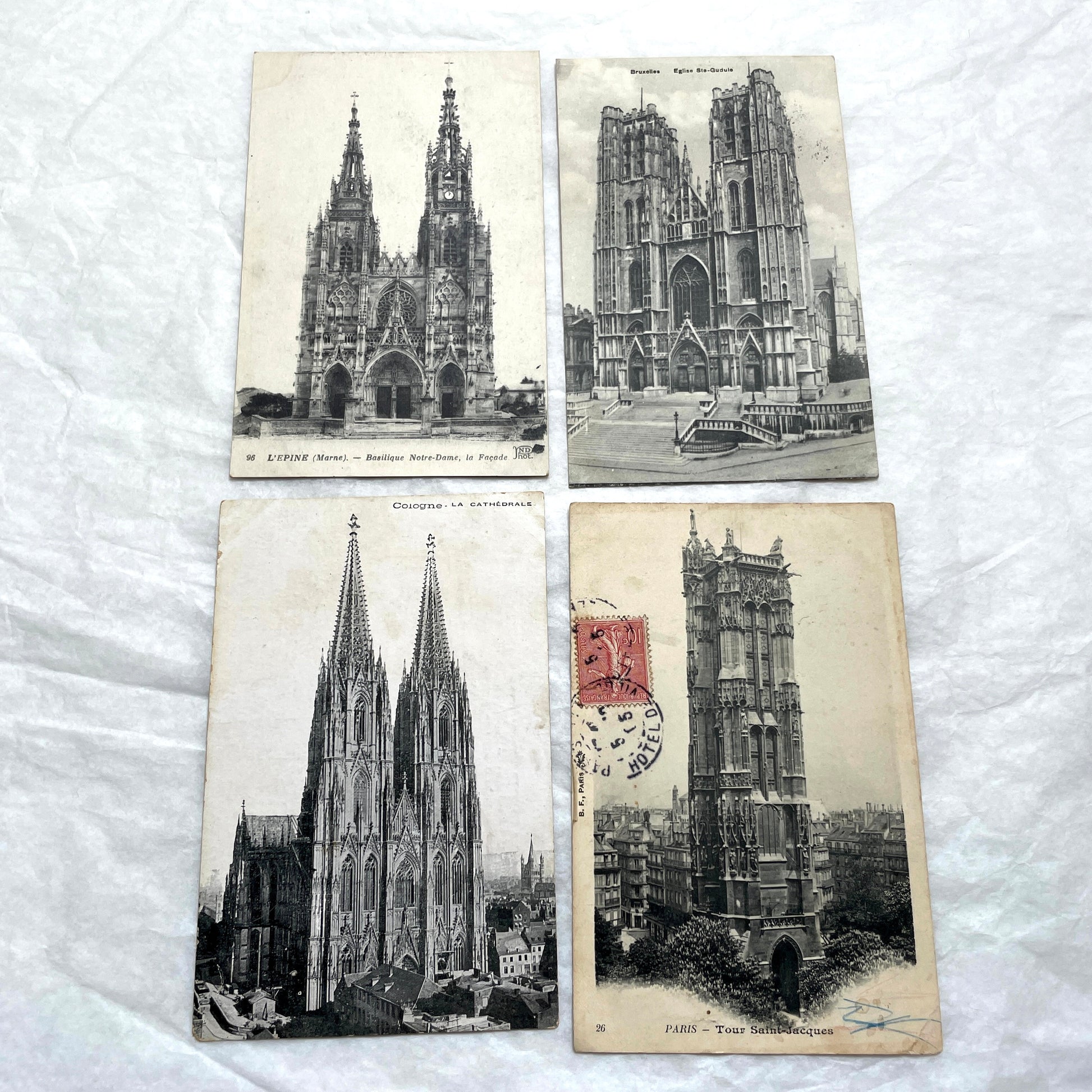 Four 1900s vintage postcards featuring detailed black and white views of European Gothic cathedrals and iconic towers.