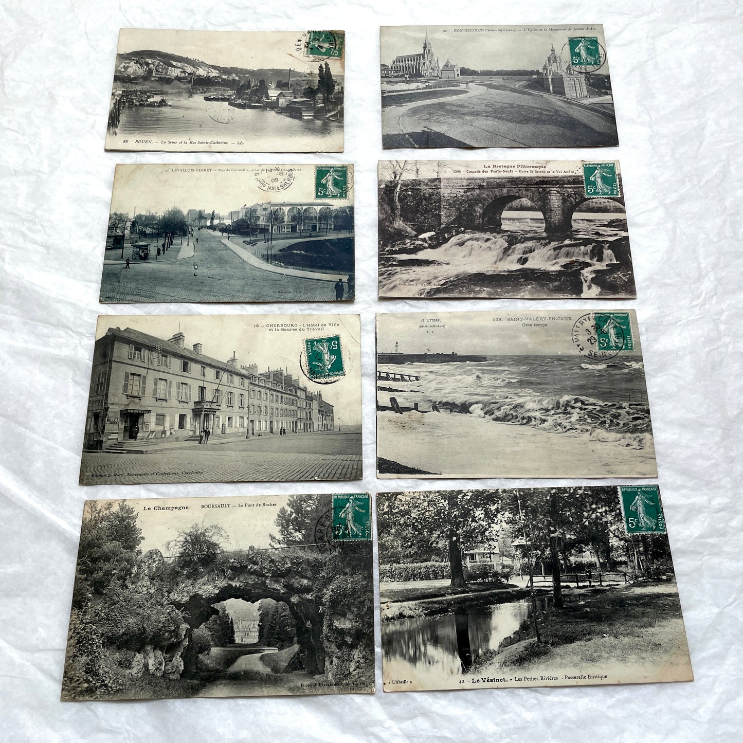 Lot of 8 1900s French postcards depicting various early 20th-century French towns, cities, and landscapes.