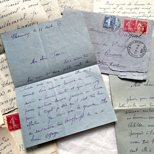 1930s French handwritten letters lot featuring vintage stamps, postmarks, and elegant script. A historical paper collection.
