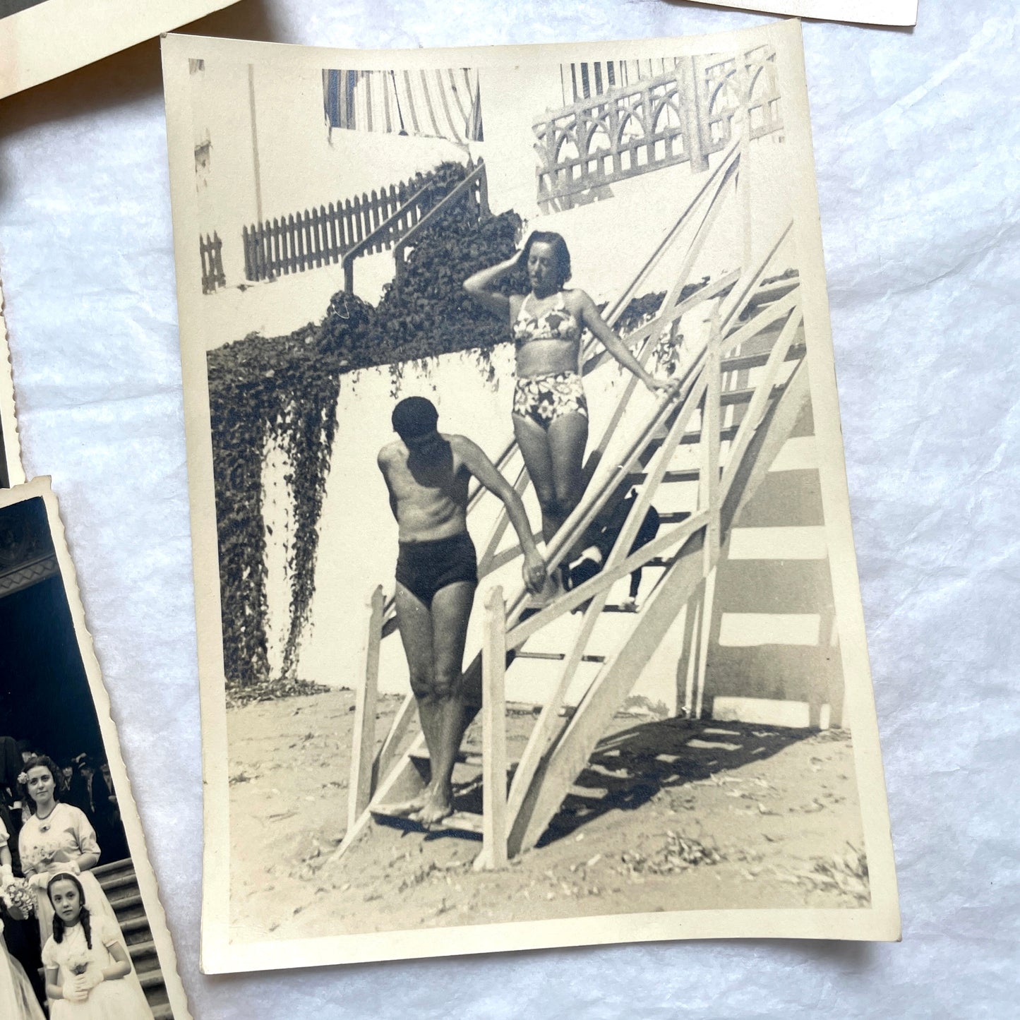 Lot of 1940s vintage photographs featuring family portraits, wedding scenes, beachgoers, and a person riding a camel.