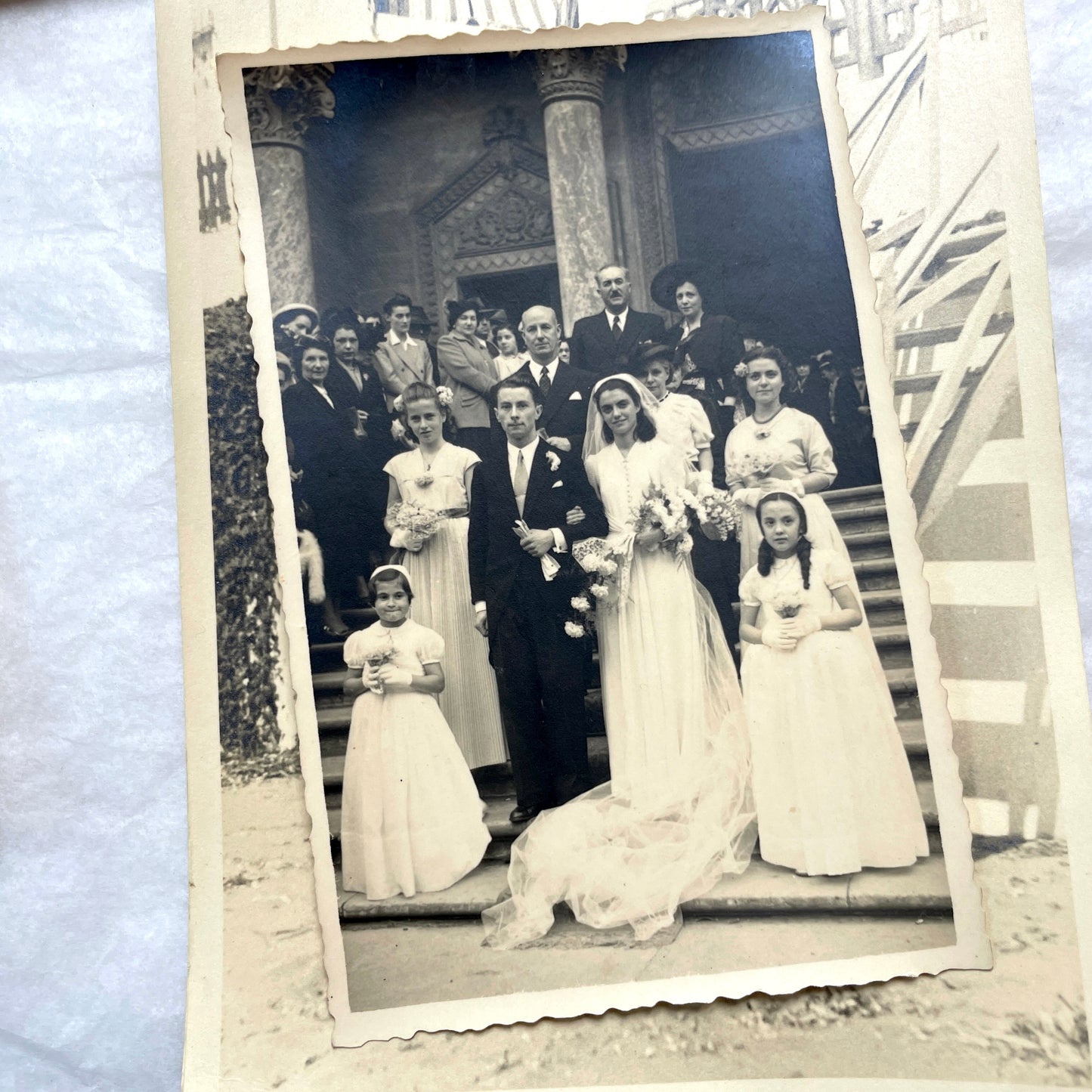Lot of 1940s vintage photographs featuring family portraits, wedding scenes, beachgoers, and a person riding a camel.
