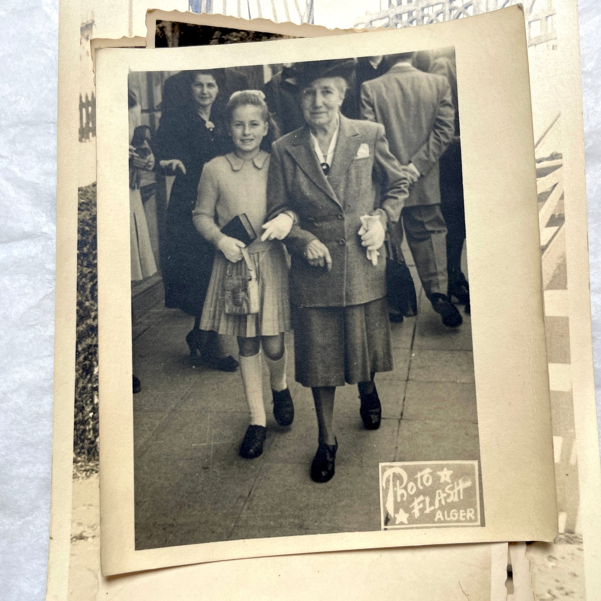 Lot of 1940s vintage photographs featuring family portraits, wedding scenes, beachgoers, and a person riding a camel.