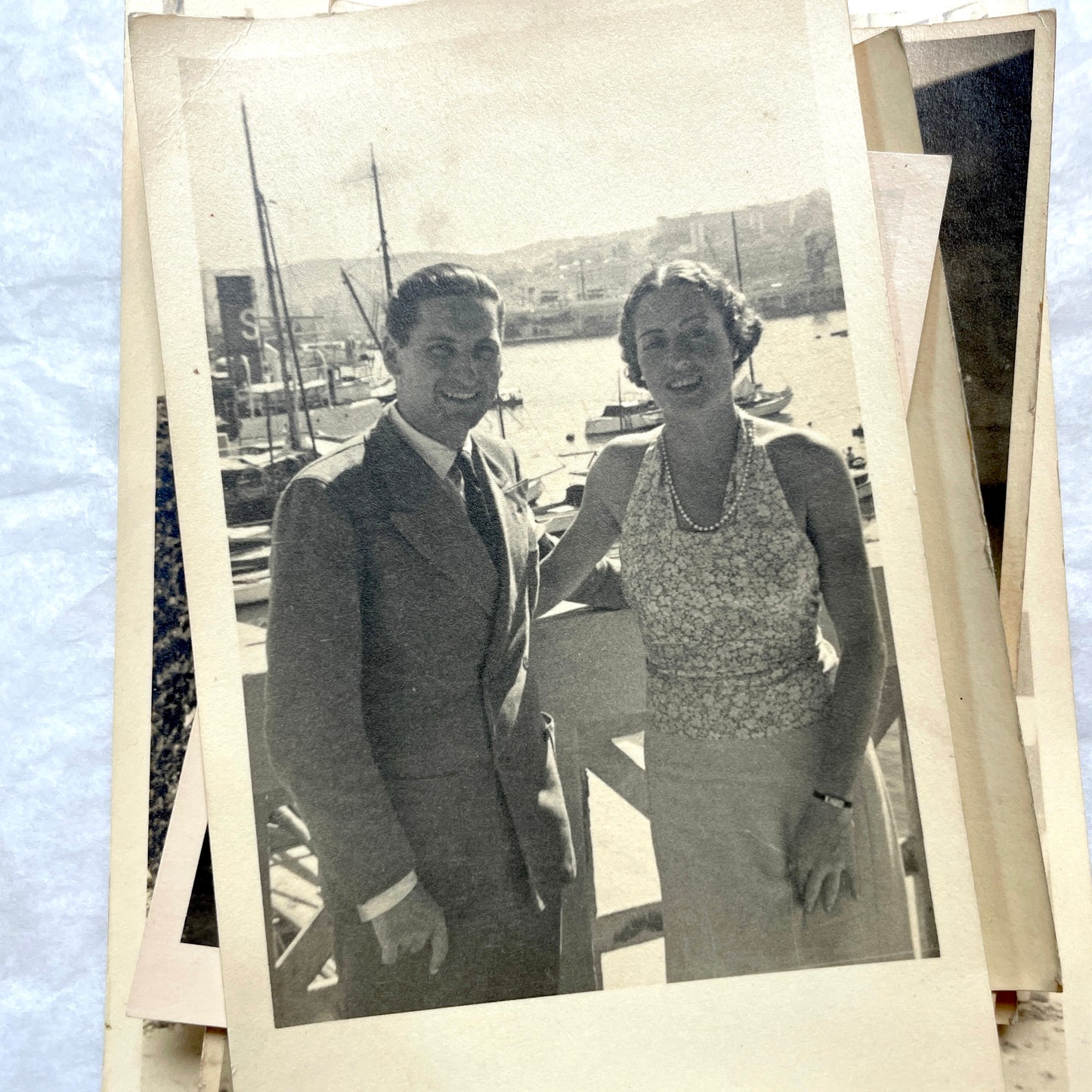 Lot of 1940s vintage photographs featuring family portraits, wedding scenes, beachgoers, and a person riding a camel.