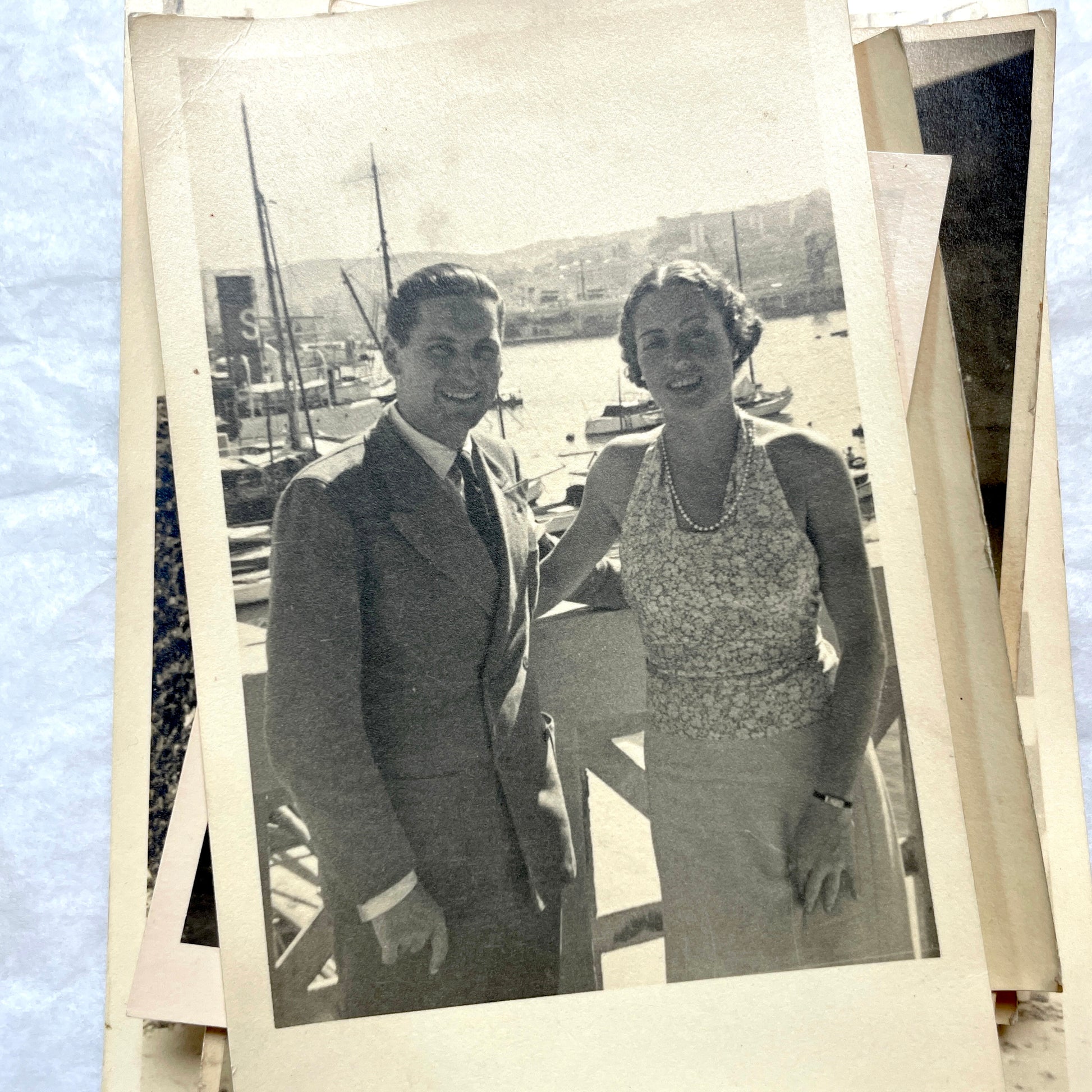 Lot of 1940s vintage photographs featuring family portraits, wedding scenes, beachgoers, and a person riding a camel.