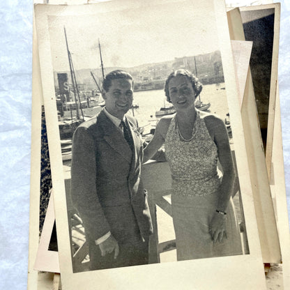 Lot of 1940s vintage photographs featuring family portraits, wedding scenes, beachgoers, and a person riding a camel.