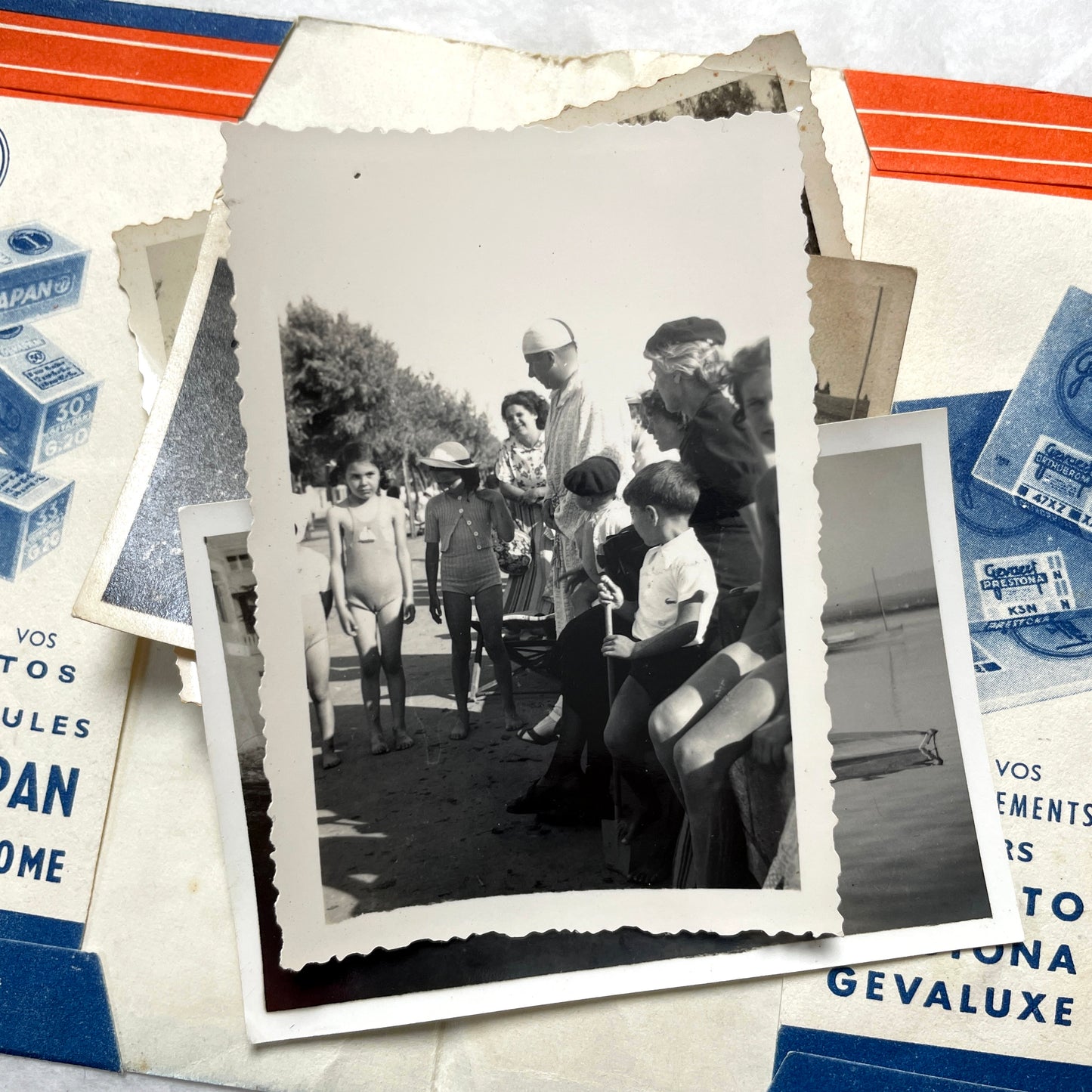 1930s vintage photographs lot showing European family life, children, classic cars, and travel scenes including a ship.