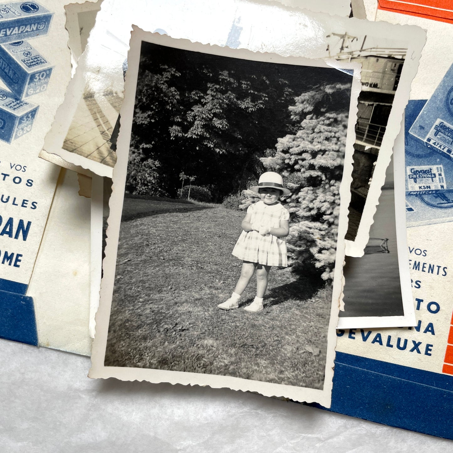 1930s vintage photographs lot showing European family life, children, classic cars, and travel scenes including a ship.