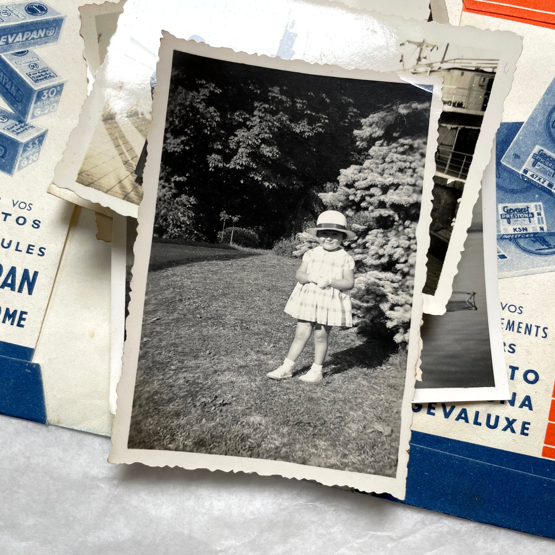 1930s vintage photographs lot showing European family life, children, classic cars, and travel scenes including a ship.