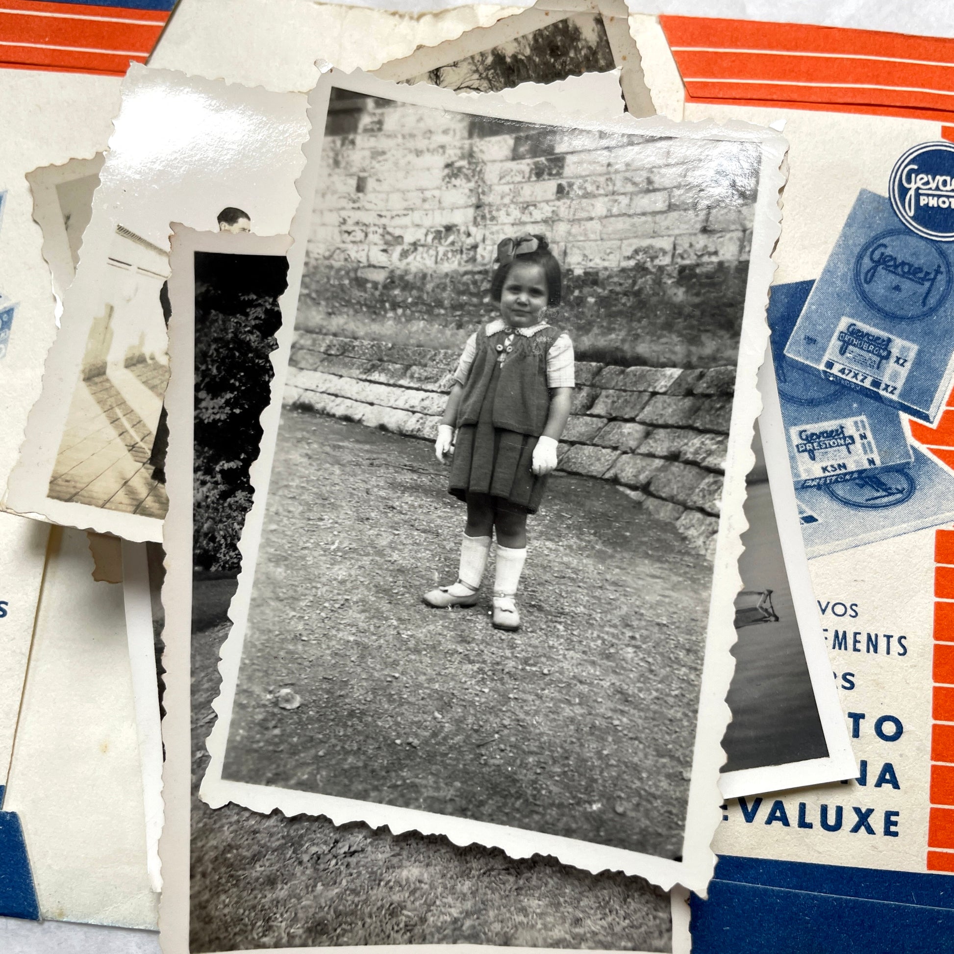 1930s vintage photographs lot showing European family life, children, classic cars, and travel scenes including a ship.