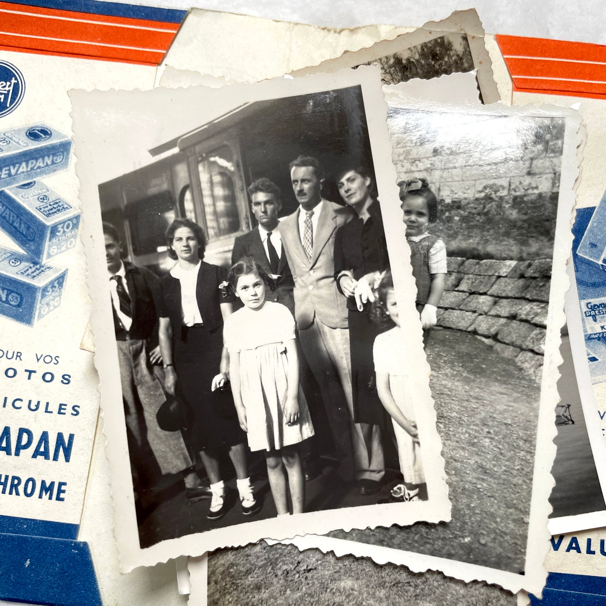 1930s vintage photographs lot showing European family life, children, classic cars, and travel scenes including a ship.