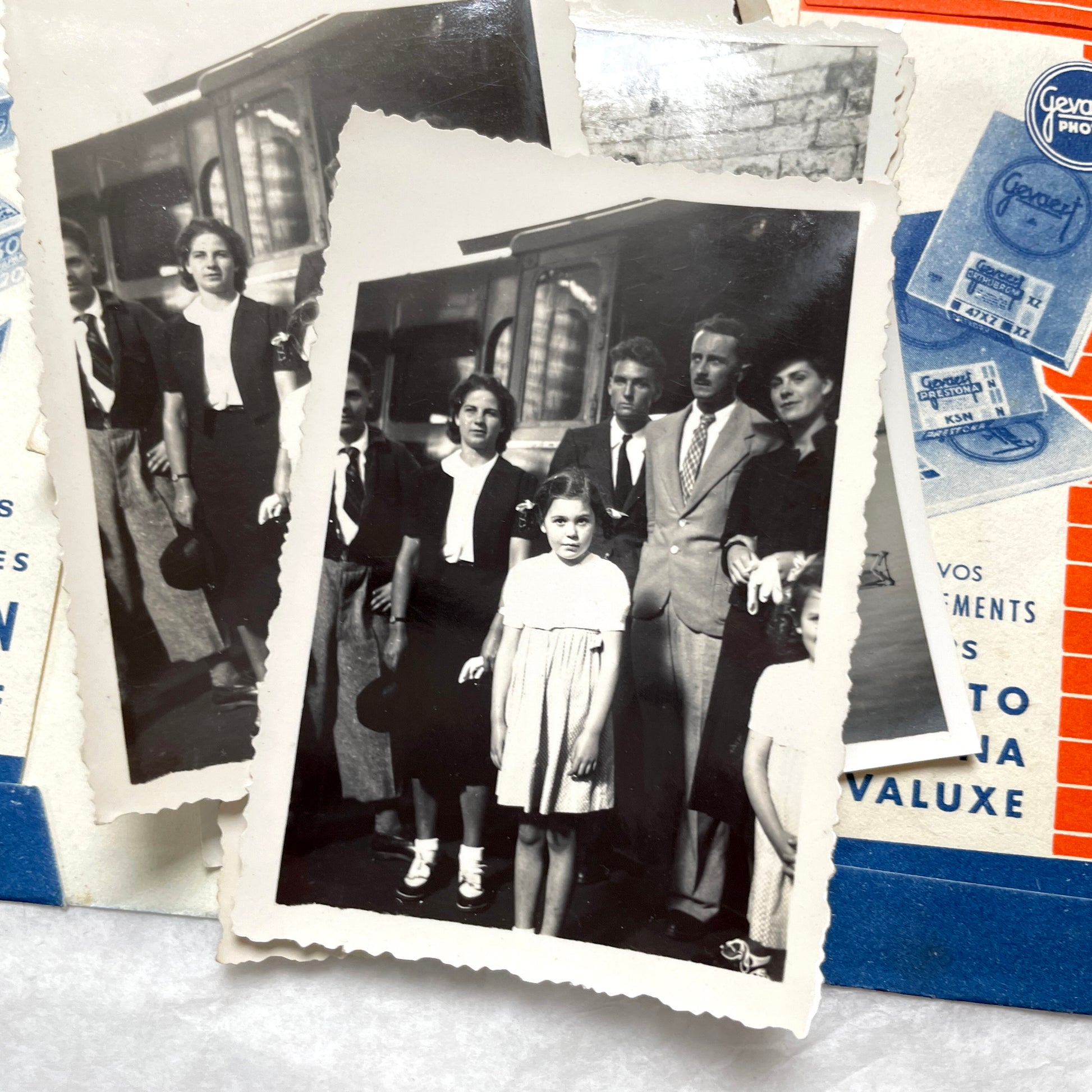 1930s vintage photographs lot showing European family life, children, classic cars, and travel scenes including a ship.