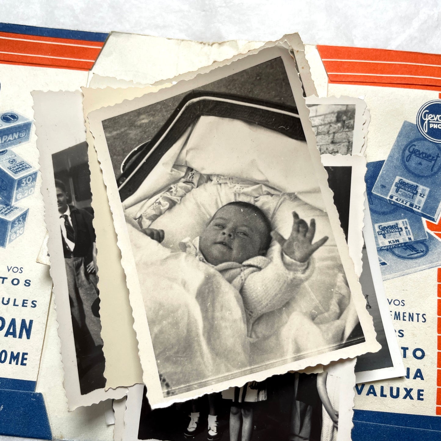 1930s vintage photographs lot showing European family life, children, classic cars, and travel scenes including a ship.