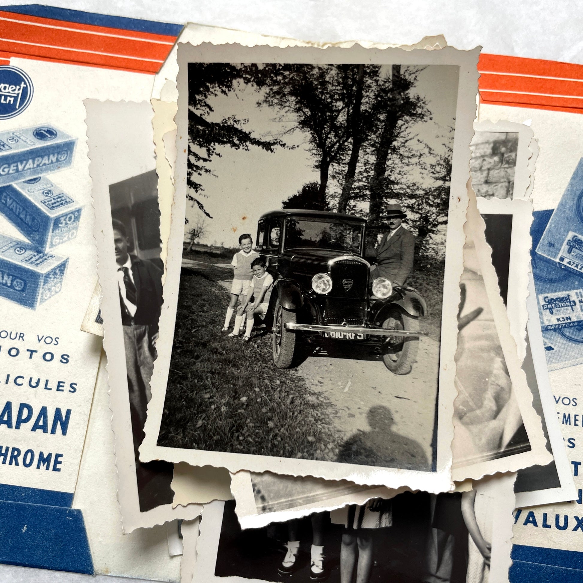 1930s vintage photographs lot showing European family life, children, classic cars, and travel scenes including a ship.