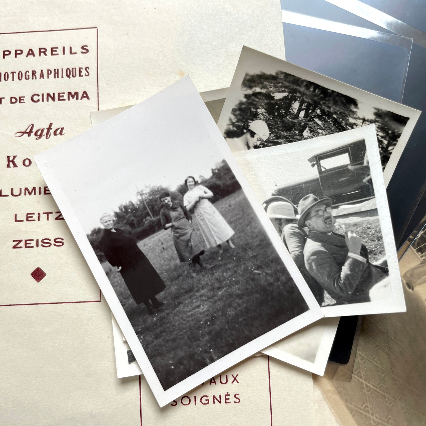 1930s vintage photograph lot showing French family life, travel, skiing, beach scenes, and a vintage car.