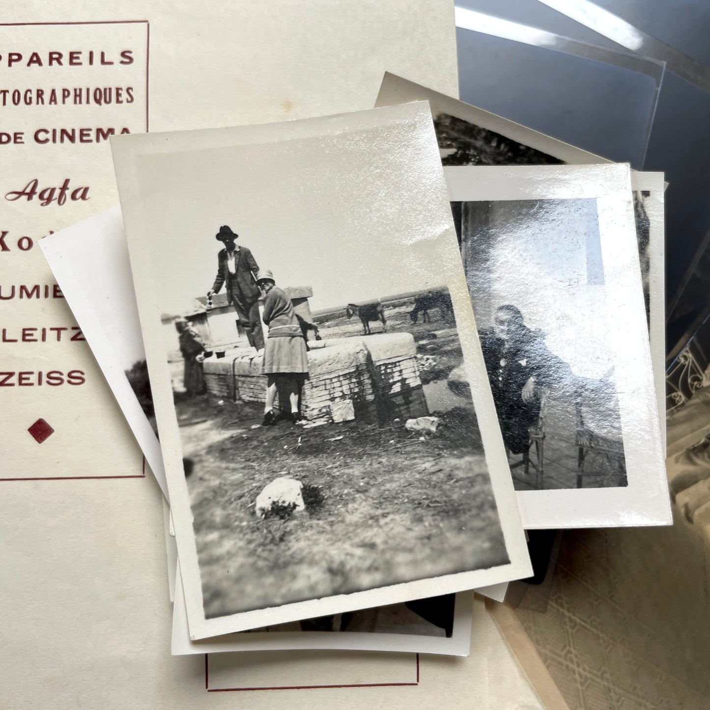 1930s vintage photograph lot showing French family life, travel, skiing, beach scenes, and a vintage car.