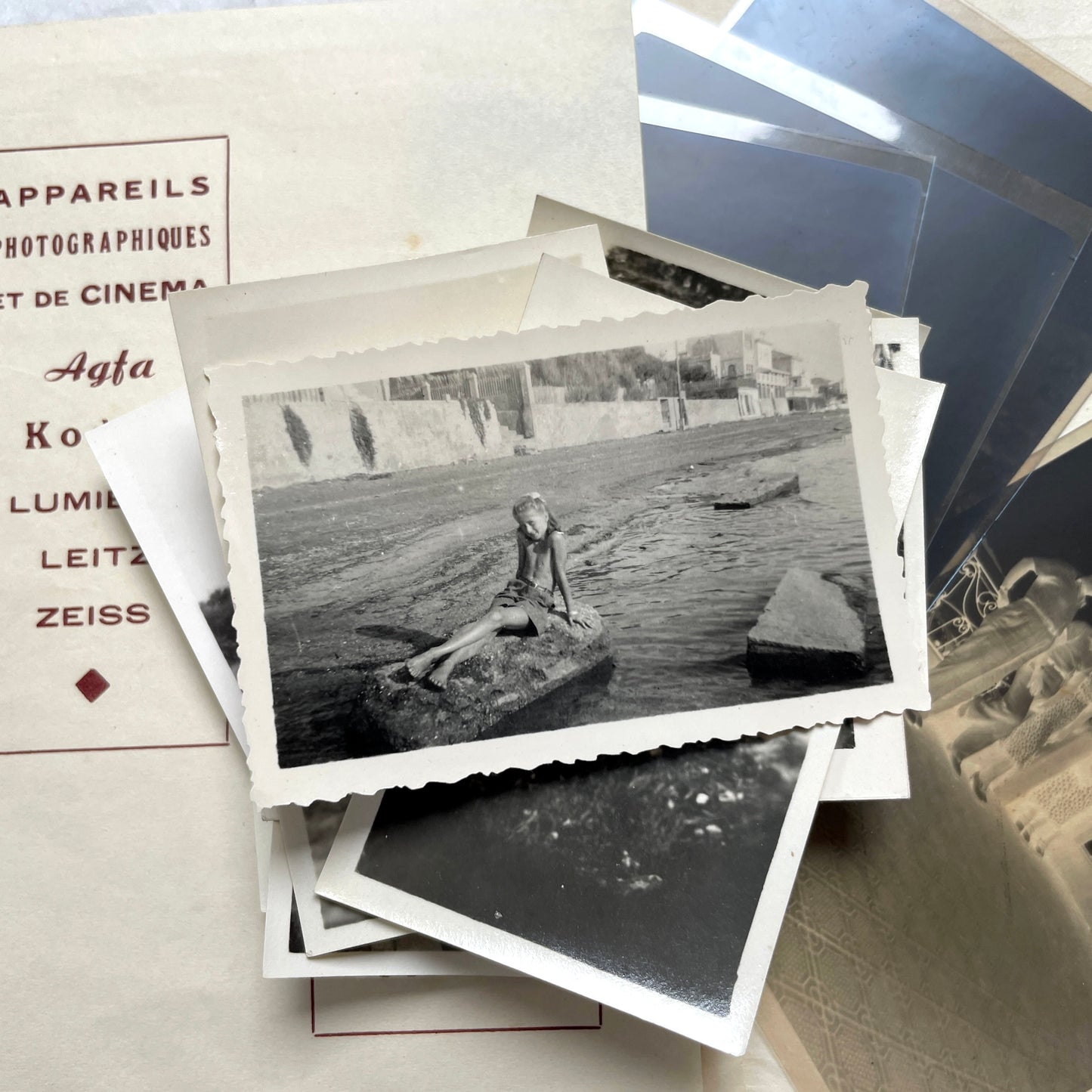 1930s vintage photograph lot showing French family life, travel, skiing, beach scenes, and a vintage car.