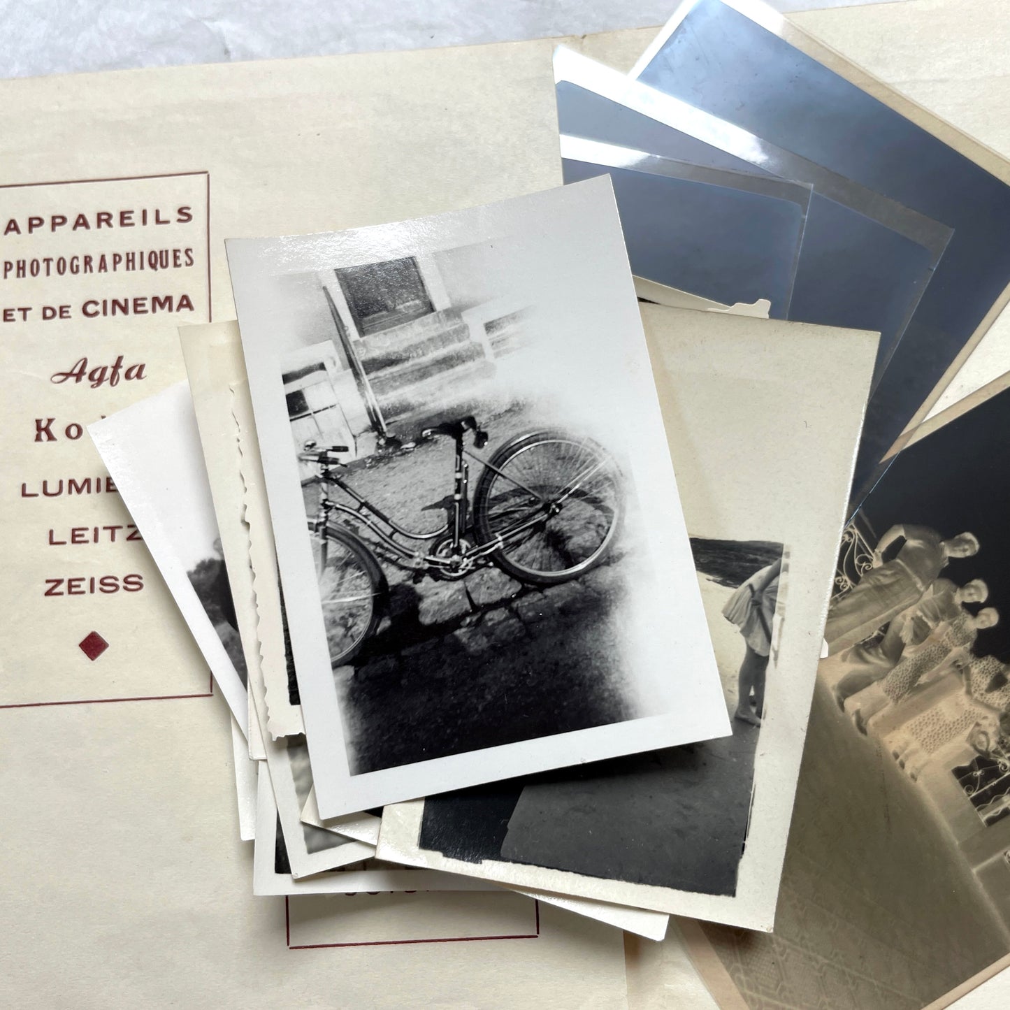 1930s vintage photograph lot showing French family life, travel, skiing, beach scenes, and a vintage car.
