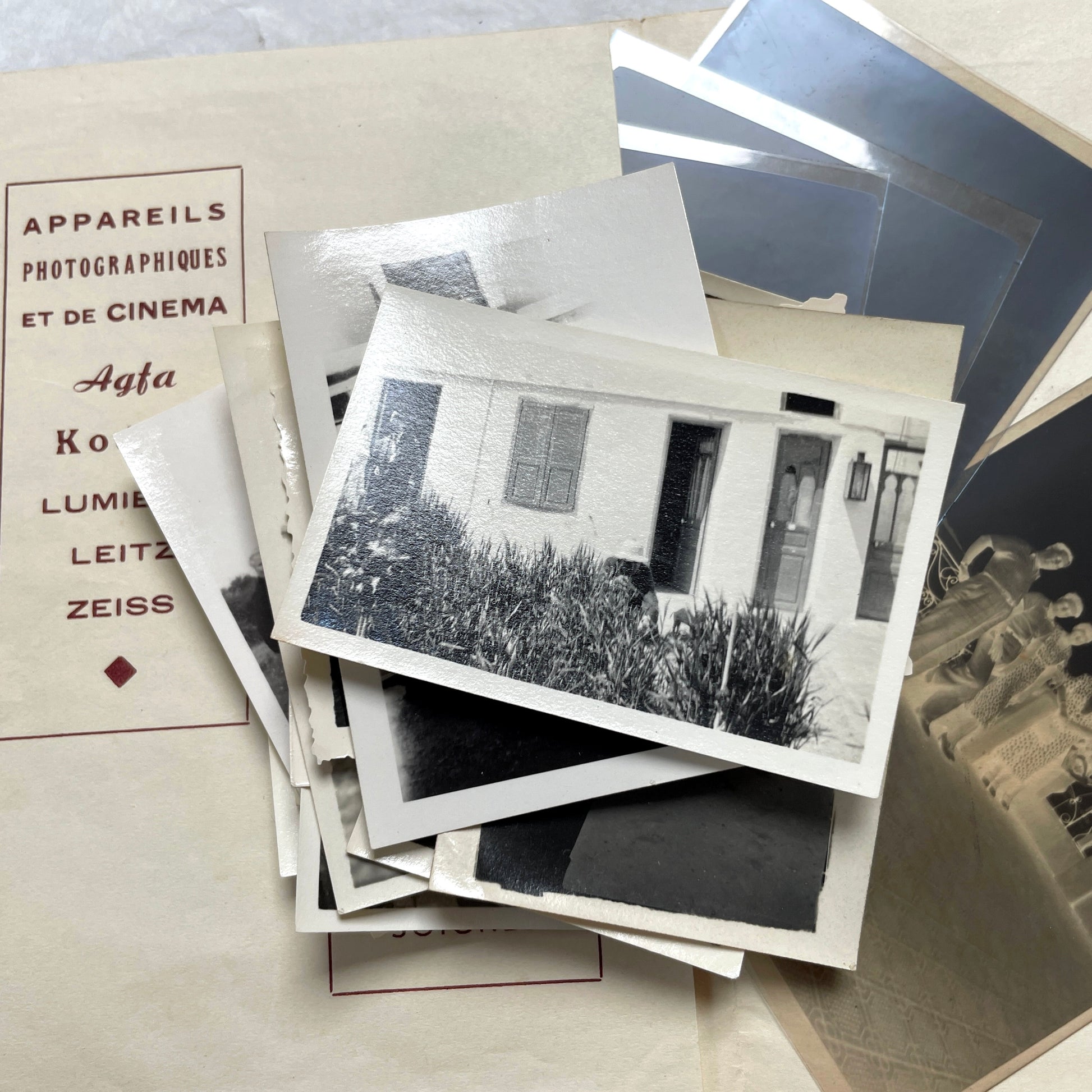 1930s vintage photograph lot showing French family life, travel, skiing, beach scenes, and a vintage car.