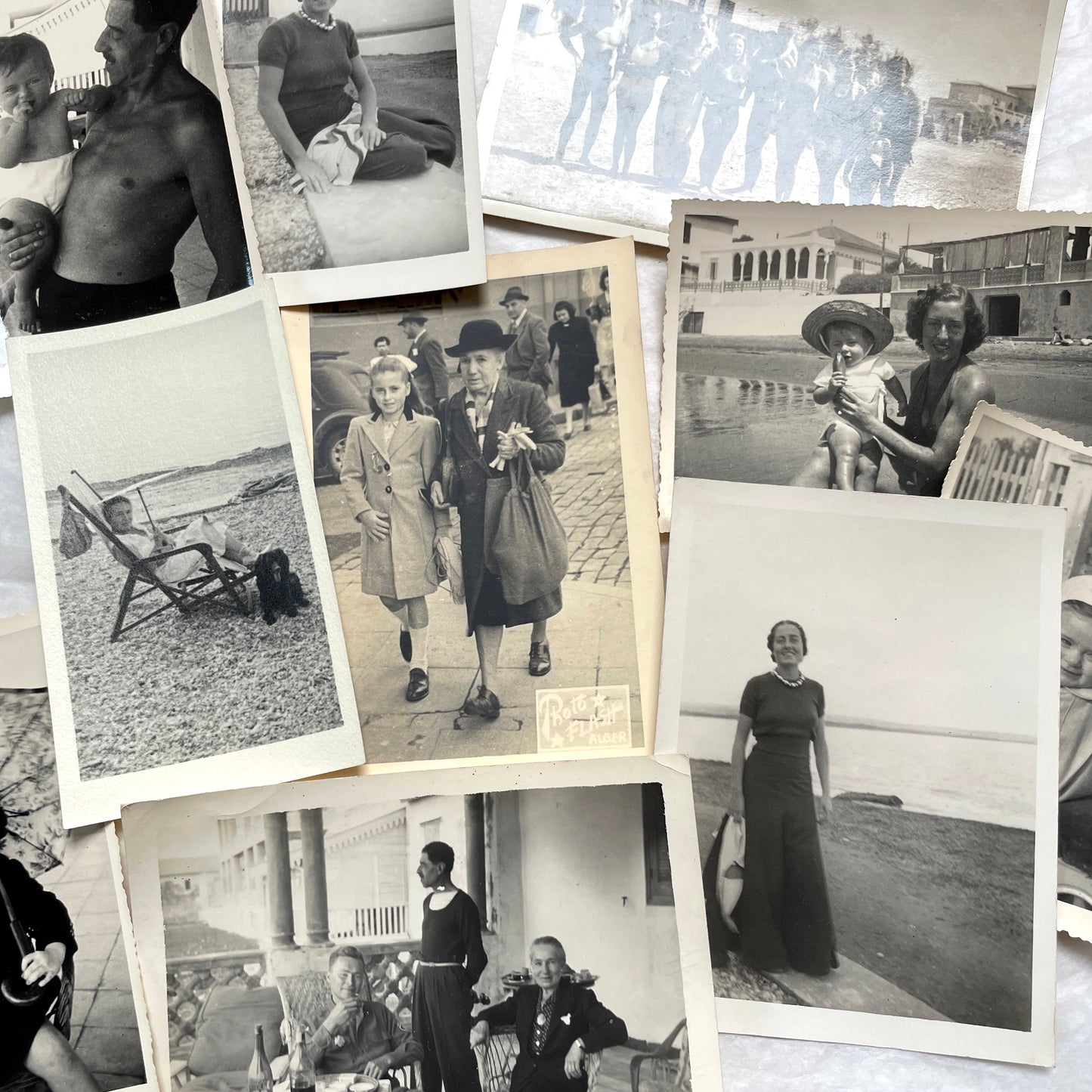1950s French photograph lot - various black and white images of families, beach scenes, and street life in Algeria.