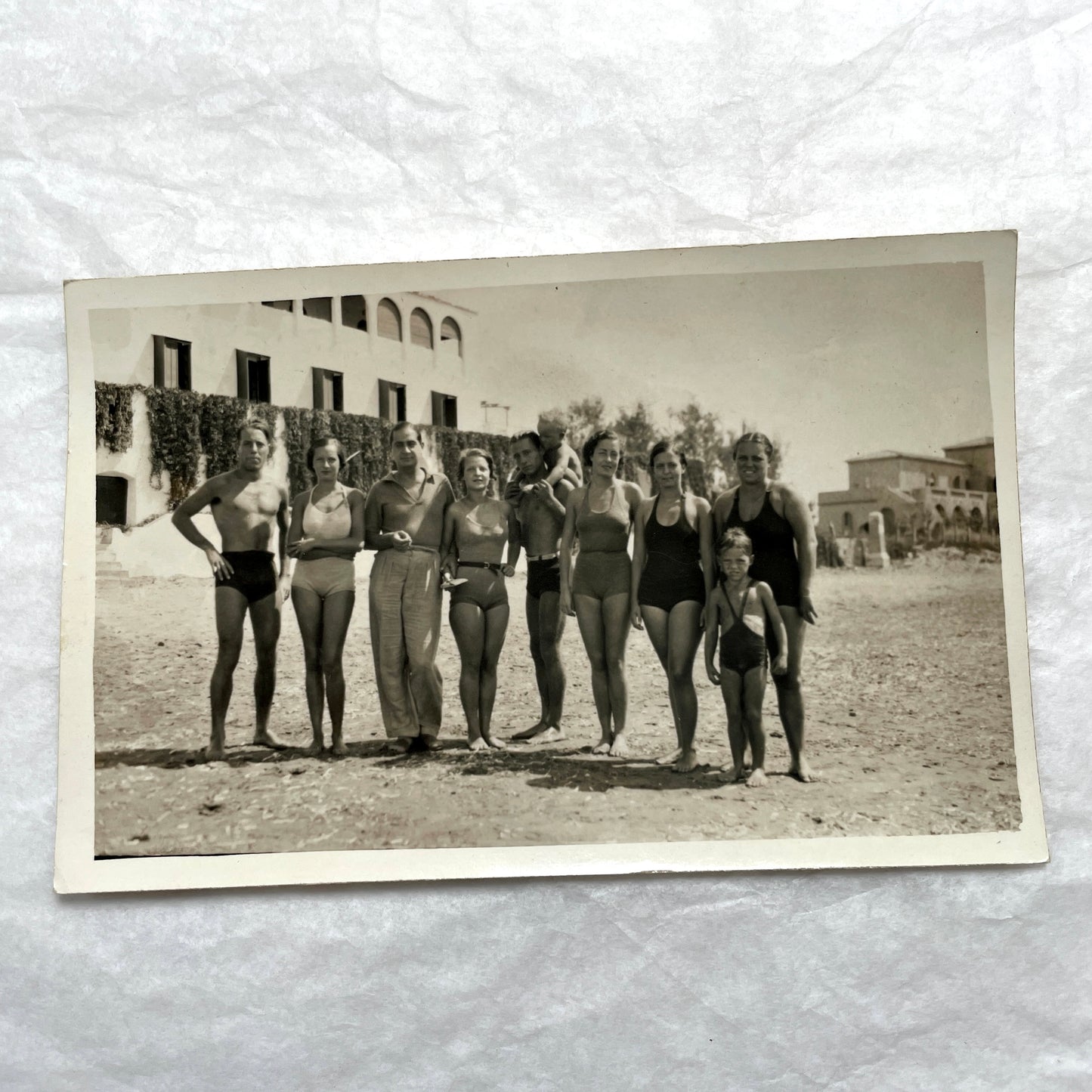 1950s French photograph lot - various black and white images of families, beach scenes, and street life in Algeria.