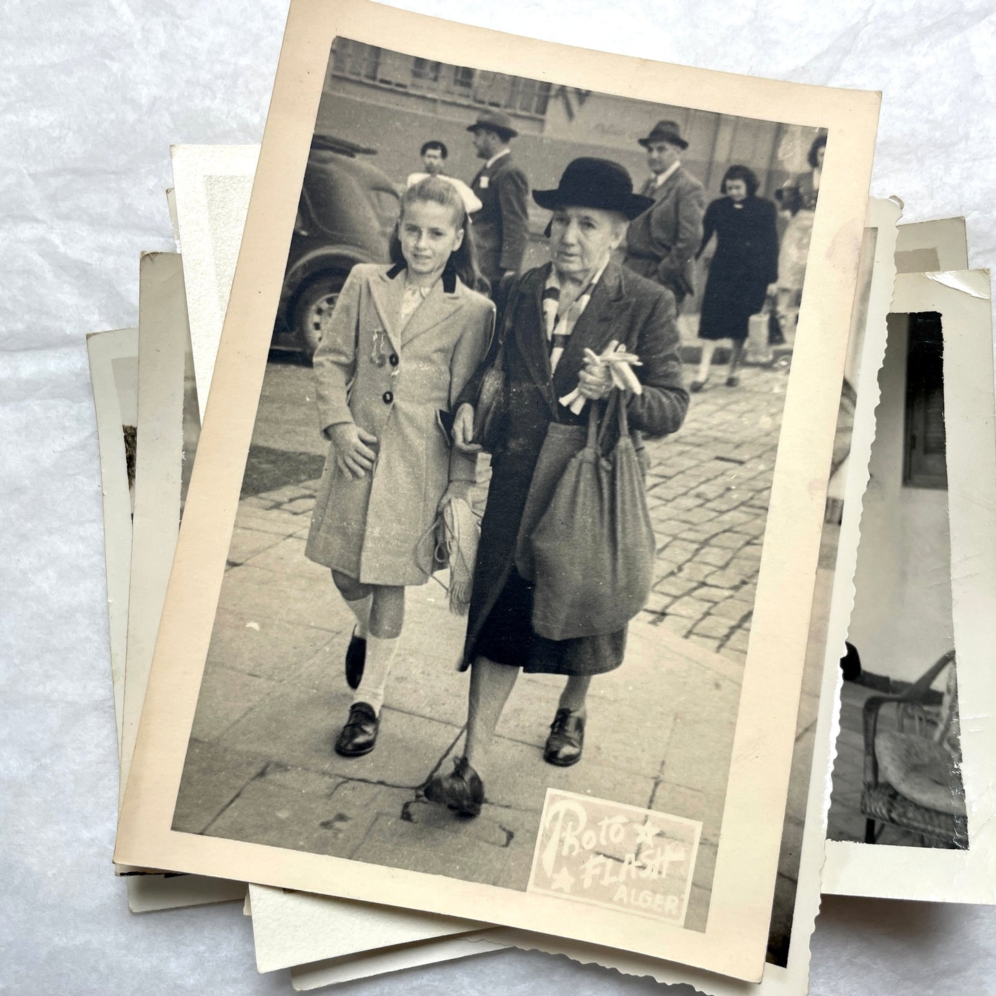 1950s French photograph lot - various black and white images of families, beach scenes, and street life in Algeria.