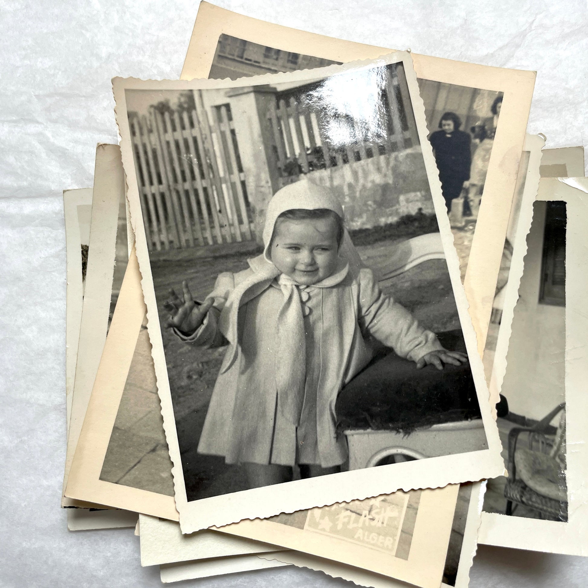 1950s French photograph lot - various black and white images of families, beach scenes, and street life in Algeria.
