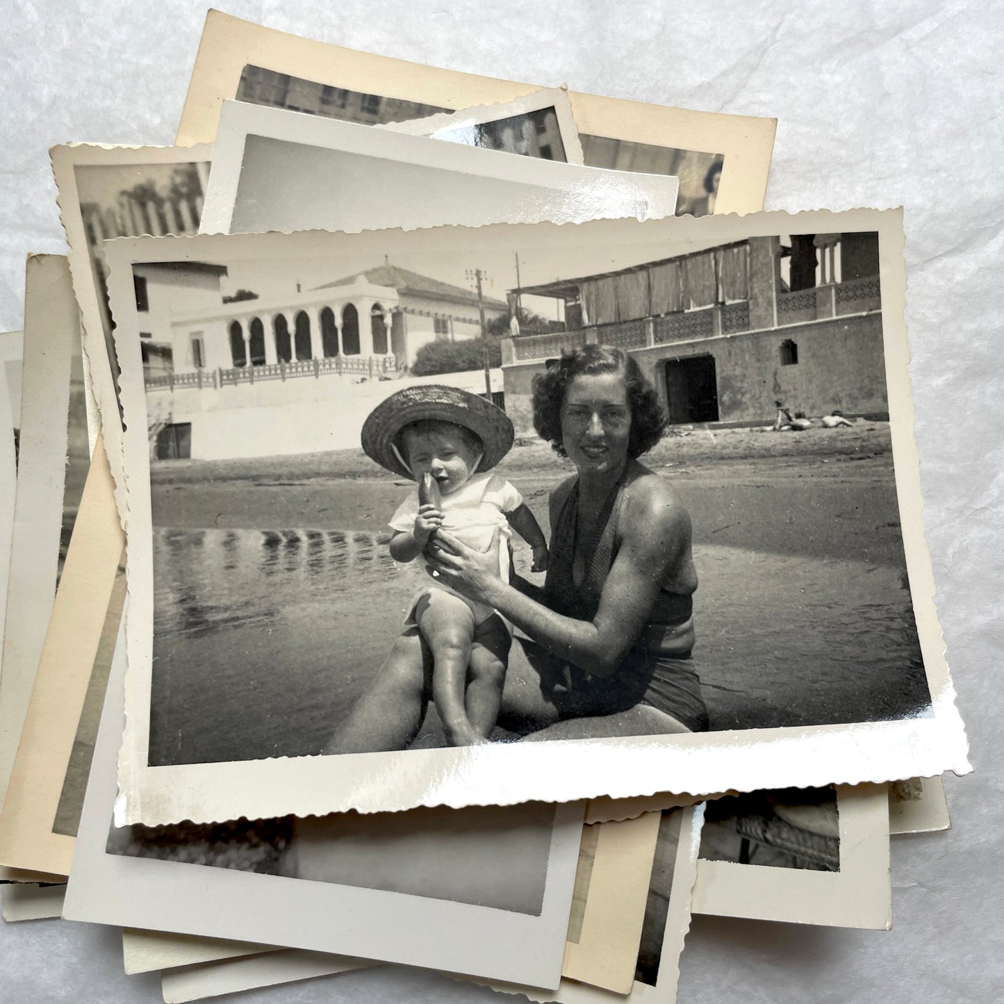 1950s French photograph lot - various black and white images of families, beach scenes, and street life in Algeria.