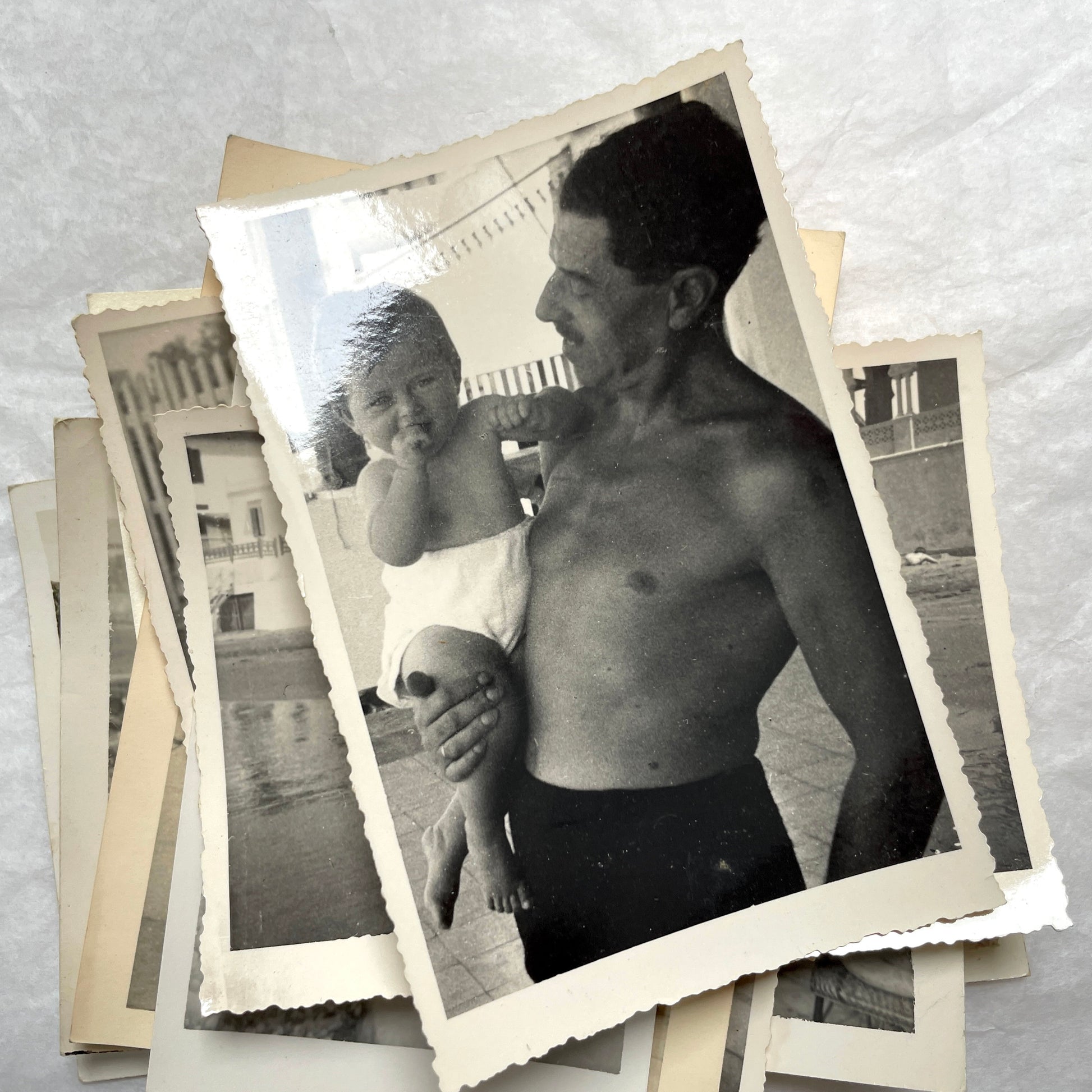 1950s French photograph lot - various black and white images of families, beach scenes, and street life in Algeria.