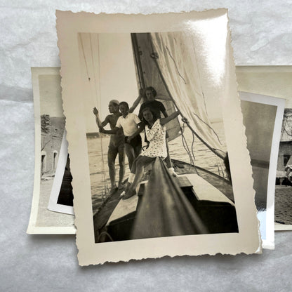 Lot of 1940s vintage photographs showing people skiing, a camel rider, an ocean scene with a military man, and a dog.