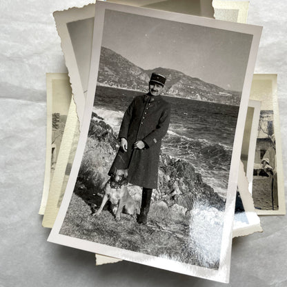 Lot of 1940s vintage photographs showing people skiing, a camel rider, an ocean scene with a military man, and a dog.
