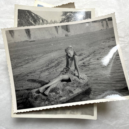 Lot of 1940s vintage photographs showing people skiing, a camel rider, an ocean scene with a military man, and a dog.