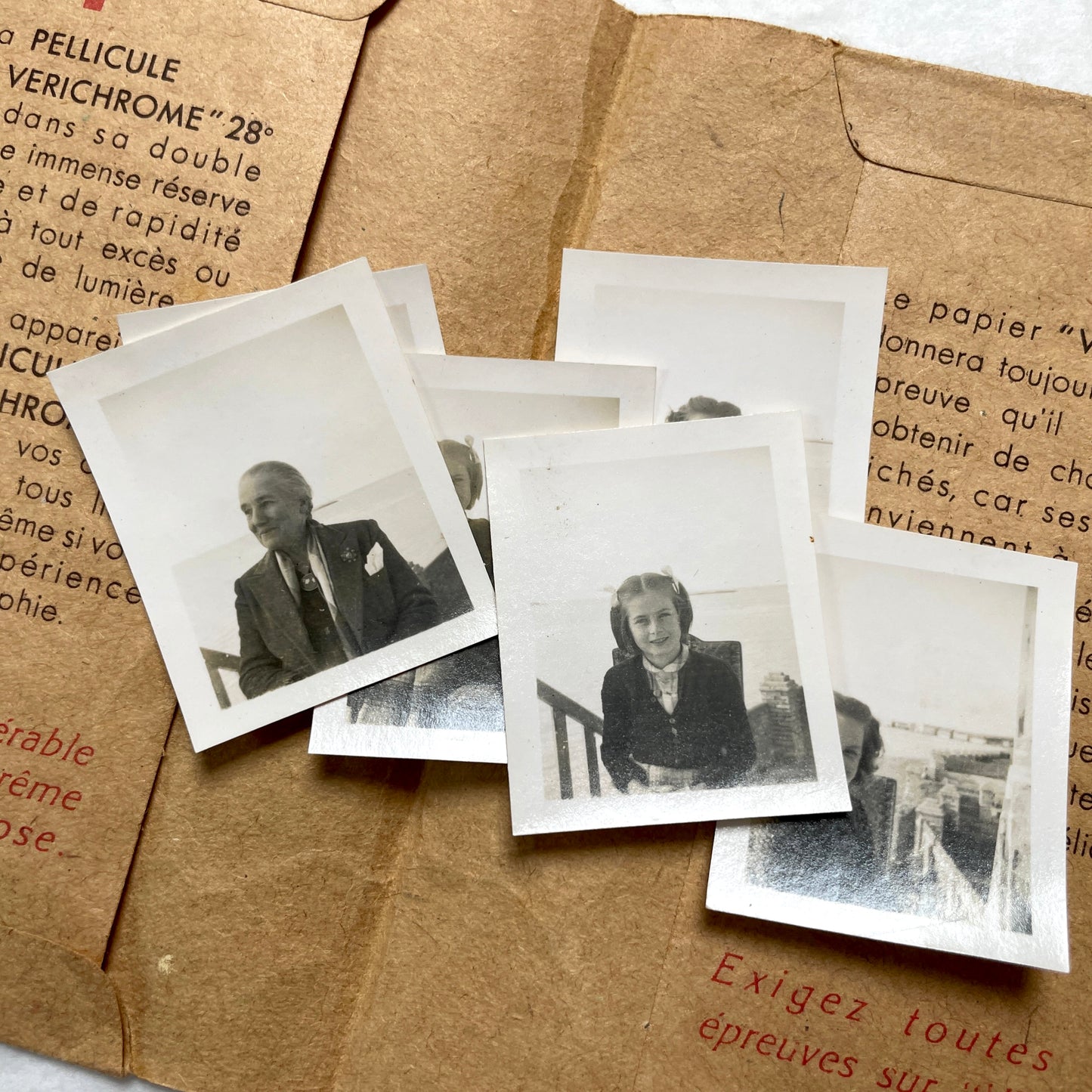 1940s vintage photographs lot featuring assorted black and white family portraits and scenes on a classic Kodaks bag.