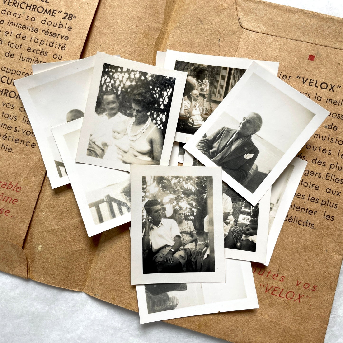 1940s vintage photographs lot featuring assorted black and white family portraits and scenes on a classic Kodaks bag.