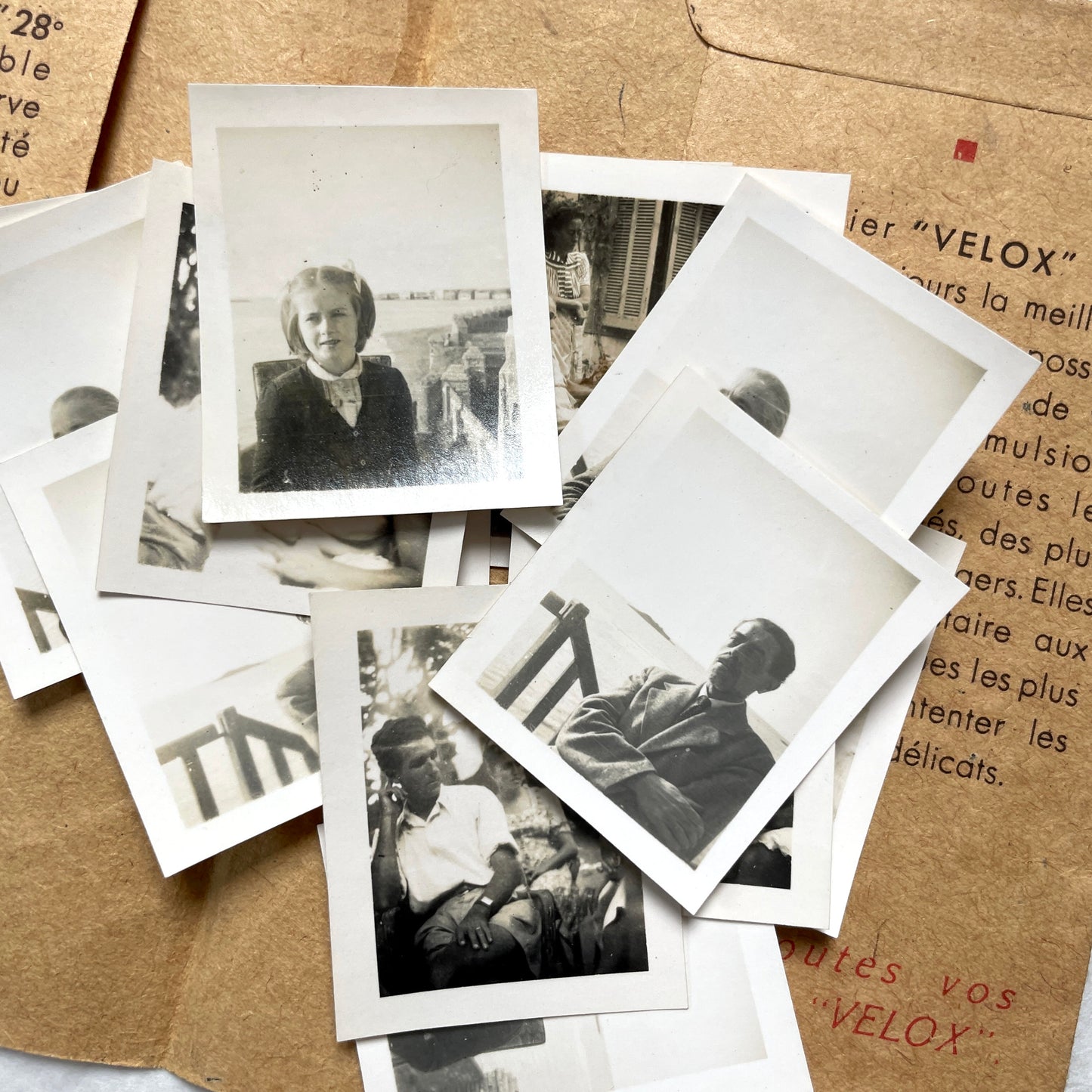 1940s vintage photographs lot featuring assorted black and white family portraits and scenes on a classic Kodaks bag.