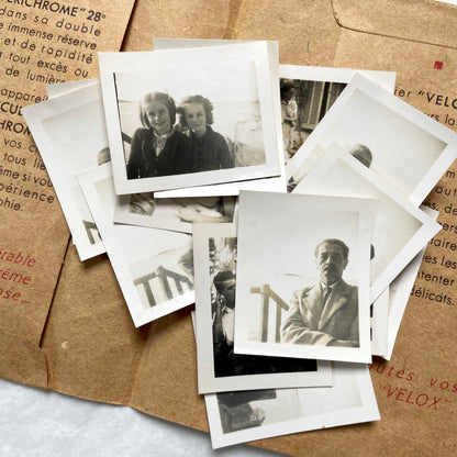 1940s vintage photographs lot featuring assorted black and white family portraits and scenes on a classic Kodaks bag.
