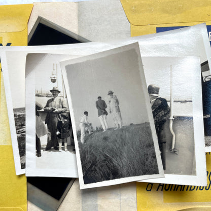 1920s vintage photograph lot showing people skiing in mountains, riding camels in the desert, and gathered on a ship deck.