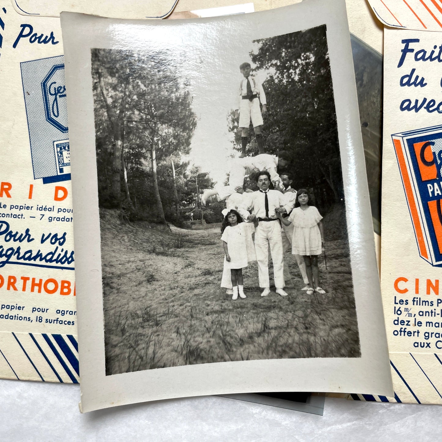 1930s French vintage photographs lot with Gevaert film and paper ephemera, showing everyday life and advertisements.