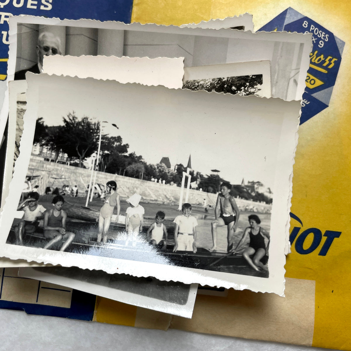 1930s vintage French photo lot with black and white pictures of family, children on the beach, and elegant couples.