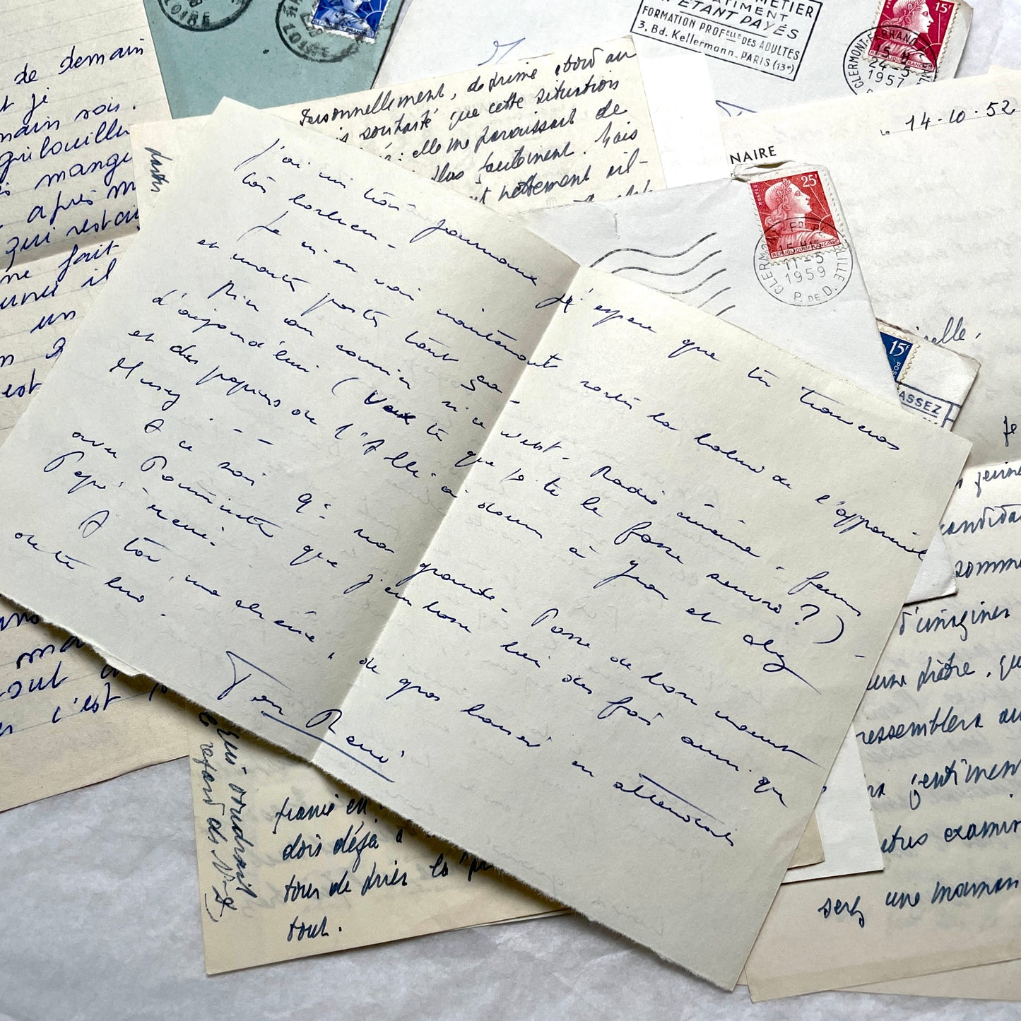 Set of 5 1950s French handwritten letters with envelopes and vintage stamps, showing personal correspondence.
