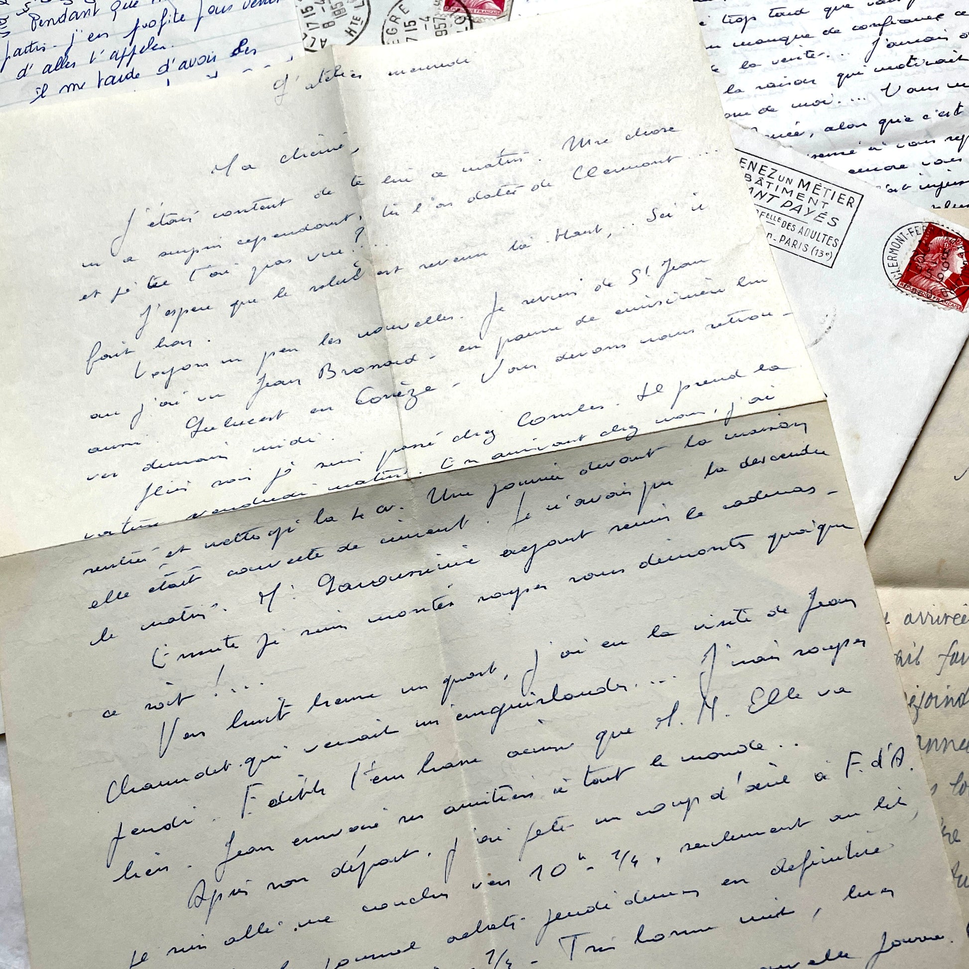 Set of 5 1950s French letters with envelopes, featuring handwritten script, vintage stamps, and postmarks.