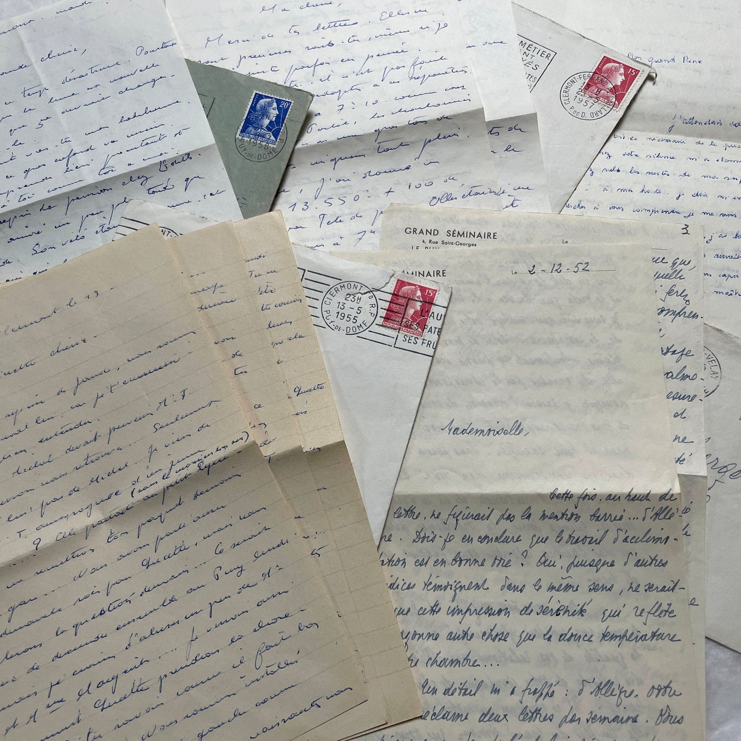 A set of 1950s French letters and envelopes with handwritten text, original stamps, and various postmarks from France.