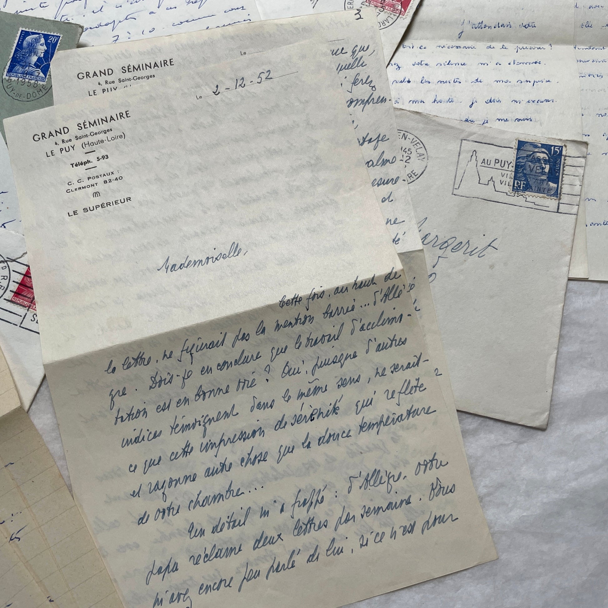 A set of 1950s French letters and envelopes with handwritten text, original stamps, and various postmarks from France.