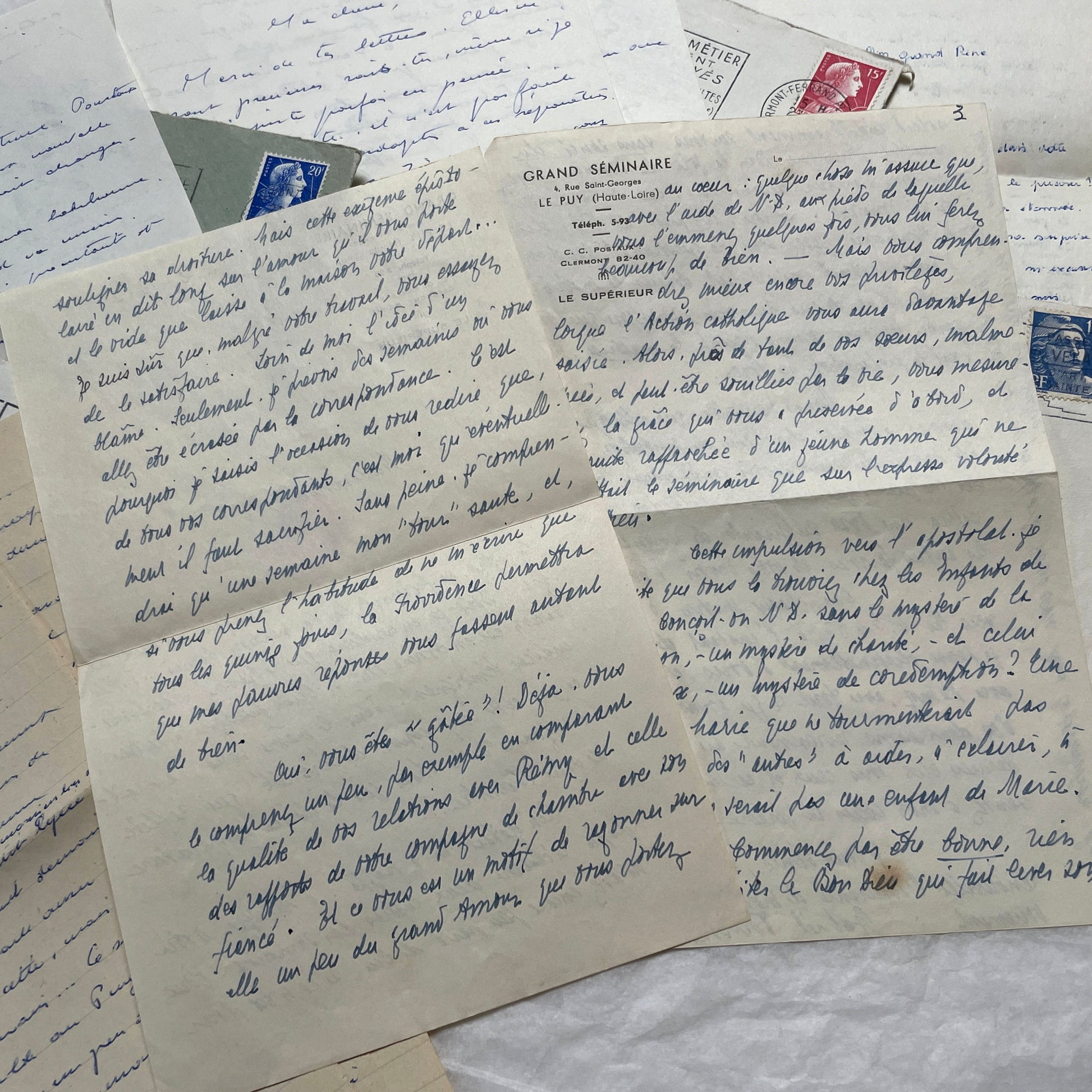 A set of 1950s French letters and envelopes with handwritten text, original stamps, and various postmarks from France.
